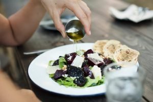 pumpkin seed oil dressing a salad with oil